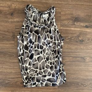 Sleeveless top-feels silky. Semi sheer- comfortable. Keyhole buttons on back.